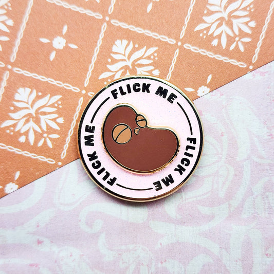 "Flick The Bean" Spinning Enamel Pin by Toku Arts